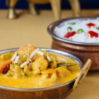 Navaratan Korma · A medley of nine vegetables cooked with mild creamy sauce topped with cashews and raisins.