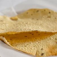 Papadum · A thin crisp lentil flour cooked in the clay oven.