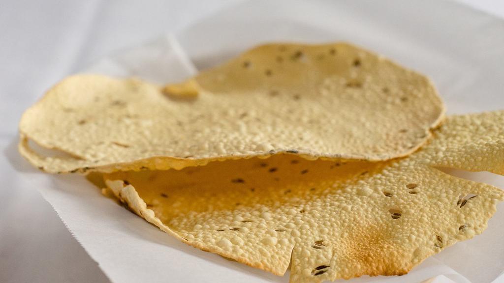 Papadum · A thin crisp lentil flour cooked in the clay oven.