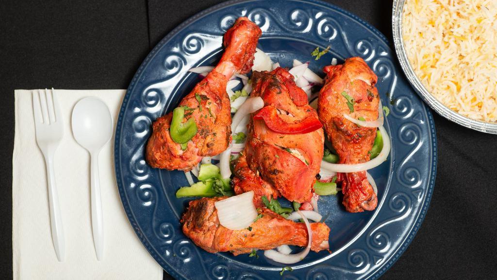 Tandoor Chicken · Chicken leg quarters marinated in yogurt, fresh spices and lemon juice then cooked in the clay oven.