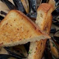 Thai Curry Mussels · black diamond mussels | house made thai curry sauce | fresh basil | garlic crustini
