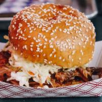 Pulled Pork Sandwich · ropey strands of hand pulled pork slathered in house BBQ sauce and our tangy vinegar pork sa...