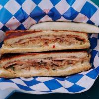 Cubano · our cuban sandwich! house-made ham and pulled pork pressed with melty swiss cheese, pickles,...