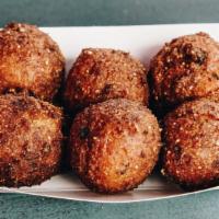 Hush Puppies · fluffy, crispy, savory cornmeal balls with shredded onion and scallion. served with a side o...