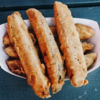 Fried Pickles · kosher deli pickle spears, breaded and fried. served with a side of our creamy burger sauce.
