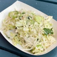 Spicy Coleslaw · a creamier, spicy version of our coleslaw with cilantro and sliced jalapeño.