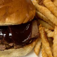 *Beef Brisket Sandwich · 6 oz of Smoked Beef Brisket served on toasted Brioche Roll with your choice of sauce.