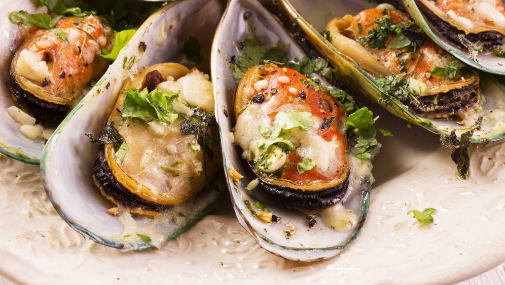 Mussels · New Zealand Green Shell Mussels, steamed to order with our spice blend and drizzled with butter garlic.