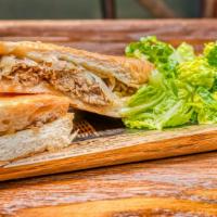 The Classic Cuban Sandwich · Chef's favorite. Cuban bread with yellow mustard loaded with roasted pork. Glazed ham, Swiss...