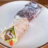 Falafel Sandwich · Falafel patties wrapped in pita bread with lettuce, tomatoes, pickled turnips, and tahini sa...