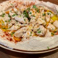 Hummus Shawarma · Hummus topped with thin sliced rotisserie chicken & garlic sauce