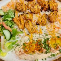Shish Taouk Platter (Chicken Kebab) · Traditional Middle Eastern skewered chicken marinated in a yogurt-based marinade, then grill...