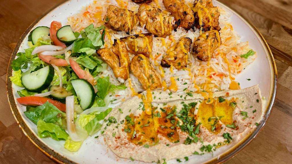 Shish Taouk Platter (Chicken Kebab) · Traditional Middle Eastern skewered chicken marinated in a yogurt-based marinade, then grilled until tender and juicy