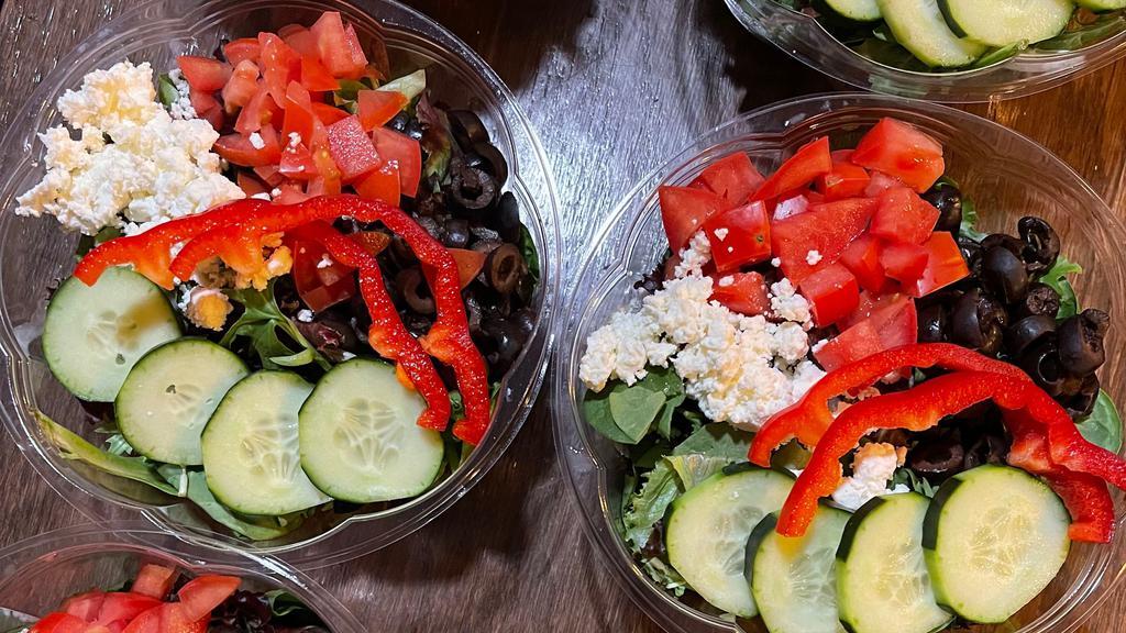 Greek Salad · Large Bowl of Mixed greens with bell pepper, cucumber, red onion, tomato, olives, and feta cheese.