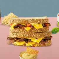 Burger Grilled Cheese · Melted american cheese, beef burger patty, caramelized onions, tomato, and mayo between two ...