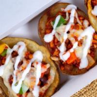 Baked Potato Skins (5 Pcs) · With cheese, bacon and sour cream.