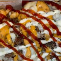 Cheesesteak Fries · Cheesesteak, American Cheese, Red & Green Peppers, Onions, Aioli, and Cheese Whiz.
