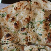 Garlic Naan · Freshly baked flatbread with garlic butter.