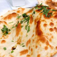 Butter Naan · Freshly baked buttery flatbread.