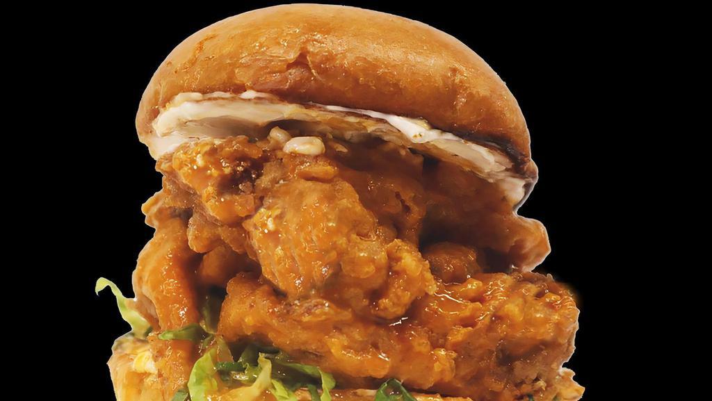 Izzit Buffalo Chik'N Sandwich · Fried oyster mushroom, tossed in our house made buffalo sauce, garlic aioli, house made pickles and lettuce on a toasted bun.