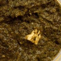 Palak Paneer · Spicy spinach cooked with pieces of fresh homemade cheese.