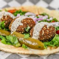 Falafel Sandwich · Three falafel balls with lettuce, parsley, Lebanese pickles, tomatoes, and tahineh sauce wra...