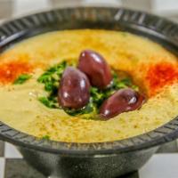 Baba Ghanouj Container · Served with pita bread, black olives, olive oil, and parsley. Made from roasted eggplant wit...