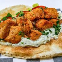 Chicken Shish Tawook Sandwich · Grilled chicken with sauteed onions, lettuce, tomatoes, garlic sauce, and parsley. Wrapped i...
