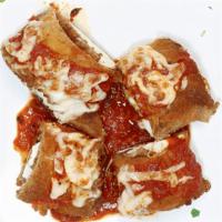 Eggplant Rollatini · Breaded eggplant rolled with ricotta cheese, topped with sauce & mozzarella cheese.