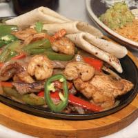 Los Agaves Fajitas · Steak, chicken and shrimp, sautéed onions, jalapeños, red and green pepper served with flour...