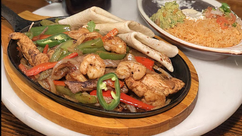 Los Agaves Fajitas · Steak, chicken and shrimp, sautéed onions, jalapeños, red and green pepper served with flour tortillas, pico De gallo, sour cream and guacamole. Served with Mexican rice and refried beans.