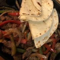 Grilled Steak Fajitas · Grilled steak, sautéed onions, jalapeños, red and green pepper served with flour tortillas, ...