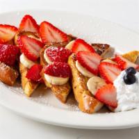 Bonjour French Toast · Classic French toast, seasonal berries & bananas topped with local maple syrup drizzle. Vege...