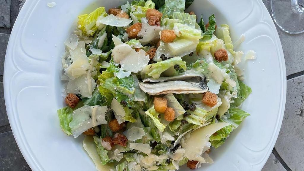 Caesar Salad · Romaine Lettuce, Shaved Parmesan, Croutons, Marinated Anchovies, 
Fried Capers, Caesar Dressing.