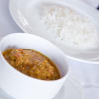 Mourgh Challow · Chicken breast sautéed with spices, yellow split peas, yogurt, cilantro, and curry. Served w...
