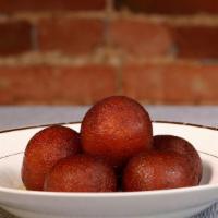 Gulab Jamun · Milk-cake rounds with nuts & cardamom filling in rosewater syrup.
