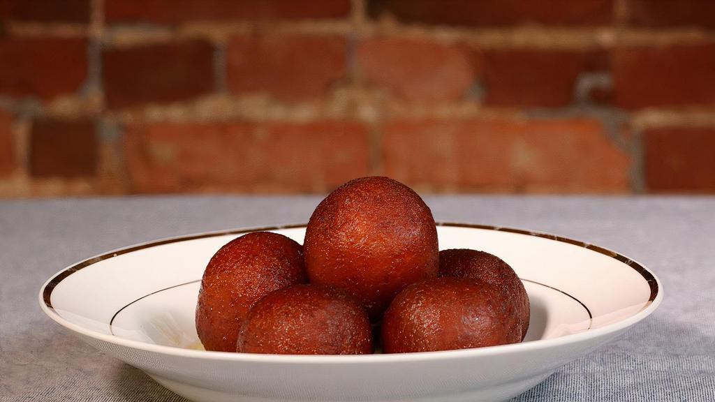 Gulab Jamun · Milk-cake rounds with nuts & cardamom filling in rosewater syrup.