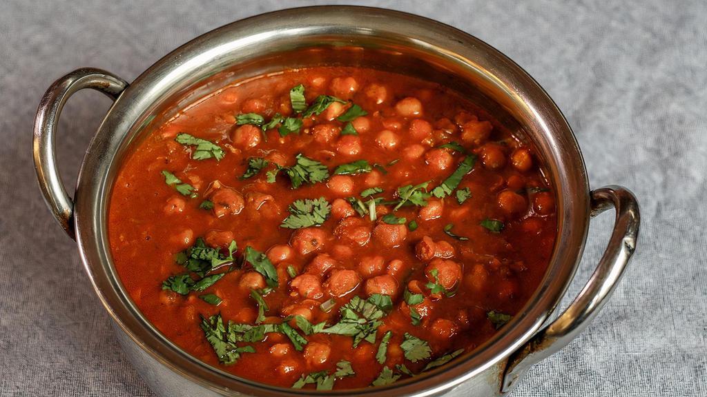 Chana Masala · Vegan, gluten-free. Tangy chickpeas in an onion-tomato sauce with ginger and spices.