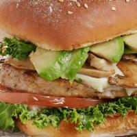 Turkey Burger · Golden brown turkey patty on a butter toasted sesame roll topped with creamy avocado, grille...