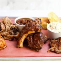 Bbq Sampler · A sample of our pulled pork, smoked brisket, pulled chicken and baby back ribs with your cho...