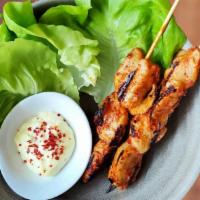 Dakkochi · Two marinated grilled chicken breast skewers served with ssam and pickled garlic aioli.