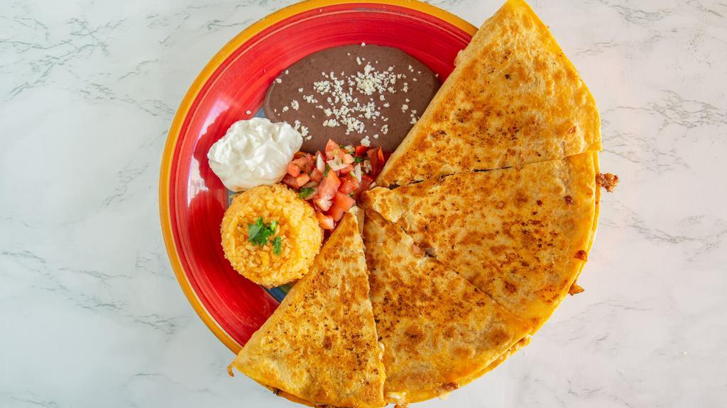 Pastor Quesadilla · Flour tortilla stuffed with cheese and spicy pork only, served with rice, beans, sour cream and pico de gallo.