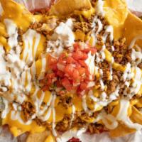 Loaded Nachos · Favorite. Tortilla chips, beans, pico de gallo,  sour cream, jalapenos with chicken and chor...