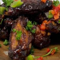 Bbq Jerk Wings  · Crispy and gently cooked wings smothered in our homemade bbq jerk sauce.
