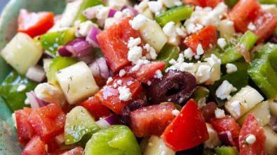 Greek Salad · chopped Romaine lettuce mixed with kalamata olives, tomatoes, shaved onion, red and green peppers and feta cheese tossed in a sherry vinaigrette.