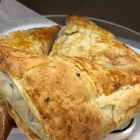 Spanakopita · Phyllo dough filled with spinach, feta cheese and fresh herbs, baked golden brown