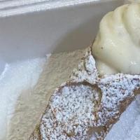 Cannoli (Large) · Freshly piped to order with sweetened ricotta cheese and chocolate chip filling in a crispy ...