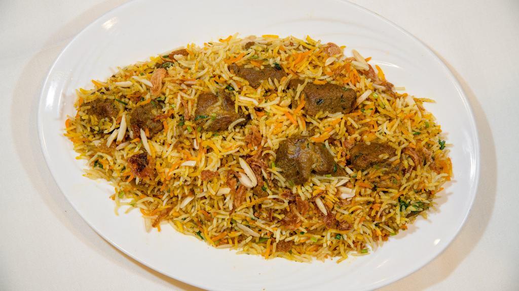 Gosht Biryani · boneless cubes of leg of lamb cooked with saffron basmati rice in mild spices and nuts. Served with raita