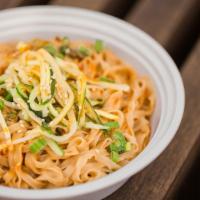Dan Dan Noodles · Thin flat flour noodles tossed in a sweet nutty soy sauce. Garnished with scallions, cucumbe...