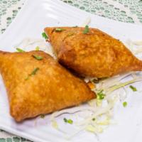 Vegetable Samosa · A crispy pastry stuffed with mildly spiced potatoes and peas.